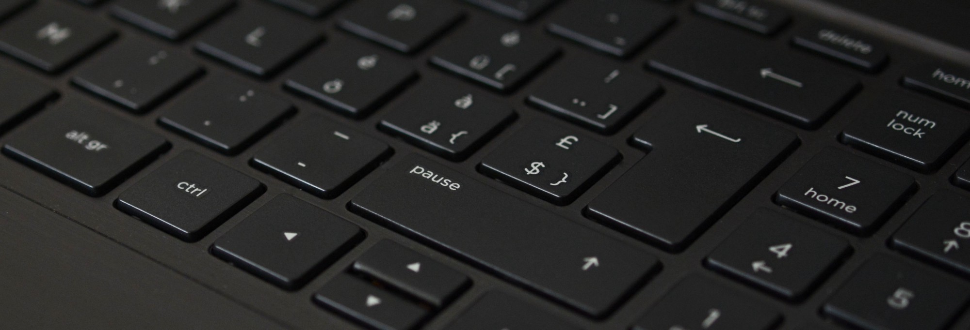 A close up, angled shot of a black computer keyboard