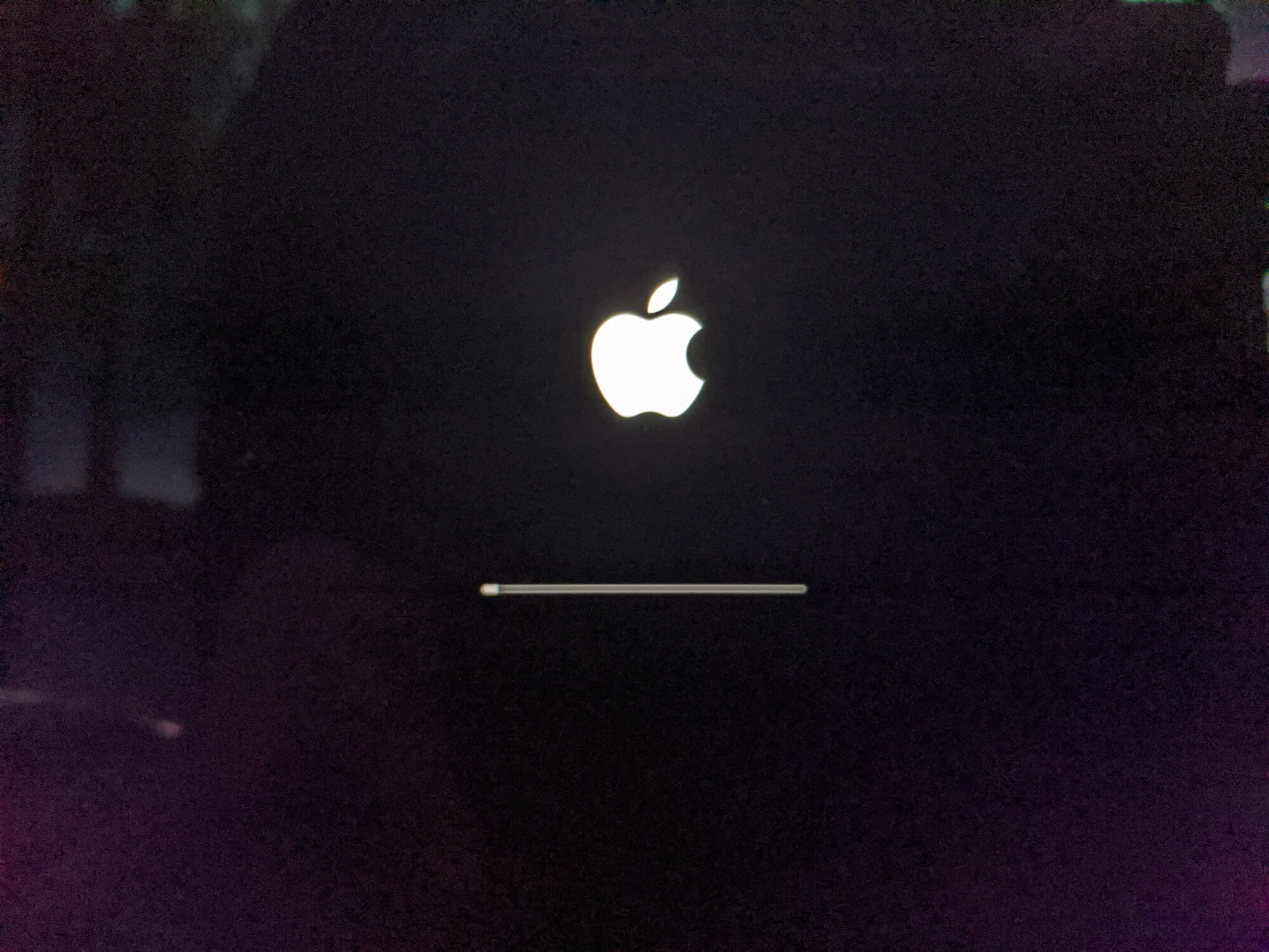 Black screen with apple logo with loading bar beneath it